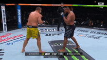 two men are fighting in a ufc ring sponsored by budlight