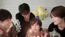 a group of young men are celebrating a birthday with a balloon that says ' pinky 20 ' on it