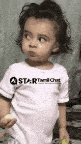 a little girl wearing a white shirt that says star tamil chat on it