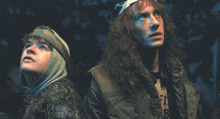 a man with long red hair is wearing a shirt that says ' lfi ' on it