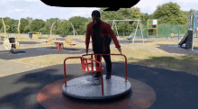a man standing on a merry go round in a park