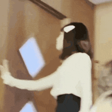 a woman is throwing a piece of paper in the air .