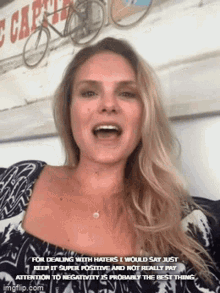 a woman is making a funny face with a caption that says for dealing with haters i would say just