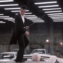 a man in a suit is standing on top of a white car