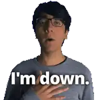 a man wearing glasses says i 'm down with his hand on his chest
