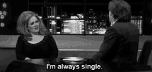 a woman sits at a table with a man and says i 'm always single ..
