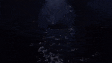 a person is floating in the water with bubbles coming out of the water
