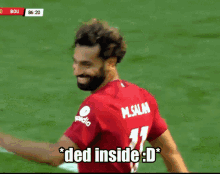 a man wearing a red shirt with the word ded inside on it