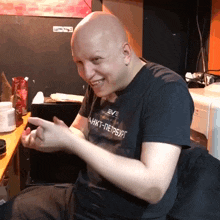 a bald man wearing a shirt that says eve