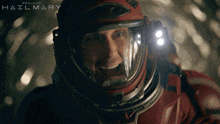 a man in a space suit is screaming in front of a project hailmary sign
