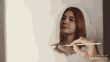 a hand is holding a brush and painting a woman 's face with the words made in animatica on the bottom