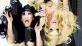 two women are standing next to each other and one has a black hat on