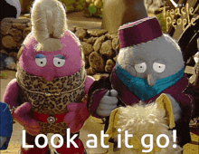 two stuffed animals standing next to each other and the words look at it go
