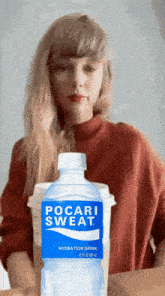 a bottle of pocari sweat sits next to a cup of coffee