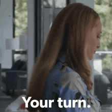a woman with long hair says your turn