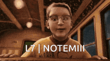 a boy wearing glasses and a yellow shirt that says l7 notemin