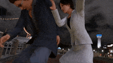 a woman in a white suit is fighting a man in a blue shirt