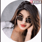 a woman wearing sunglasses is in a circle with the word roka on the bottom
