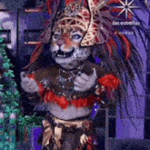 a person dressed as a leopard with feathers on their head