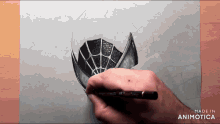 a person is drawing a spider web on a piece of paper made in animatica