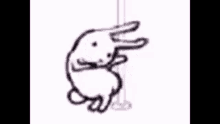 a drawing of a rabbit hanging on a pole .
