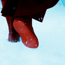 a close up of a person 's foot in the snow