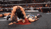 a woman laying on the ground in a wrestling ring with the word raw on the side
