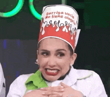 a woman wearing a chef 's hat is making a funny face and smiling .