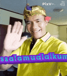 a man wearing a yellow shirt and a purple sign that says ' selamat akur '