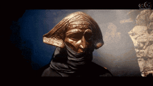 a statue of a man with a scarf around his head is displayed on a screen with the letters gc on it