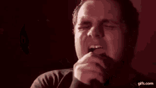 a man is being punched in the face by another man in a room .