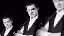 three men in tuxedos and bow ties are standing next to each other