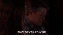a woman sits on a couch with a man and says i want grown up love