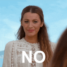 a woman wearing a white lace top stands in front of a sign that says " no "