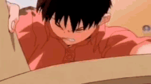 a close up of a boy in a red shirt looking at something .
