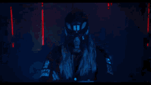 a silhouette of a person dancing in a dark room with red lights