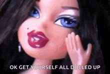 a close up of a doll 's face with the words `` ok get yourself all dolled up '' written on it .
