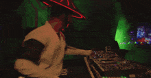 a man in a green karate outfit with a red hat