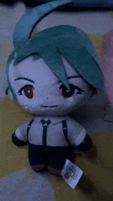 a stuffed toy with green hair and red eyes has a tag on it that says ' nintendo ' on it