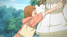 a girl in a pink jacket is hugging a man