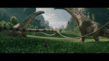 a couple of dinosaurs standing in a grassy field with mountains in the background