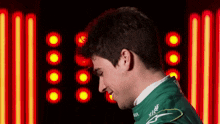 a man in a green racing suit with the word castrol on the side