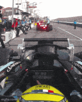 a race car with a yellow helmet that says ' head ' on it