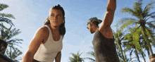 a man and a woman standing next to each other on a beach