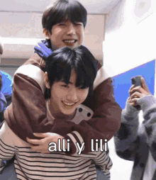 a man is carrying another man on his back with the words " alli y lili " written on the bottom
