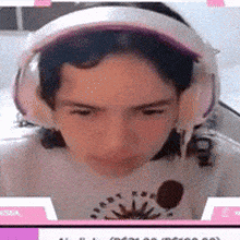 a close up of a person wearing headphones and a white shirt .