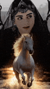 a woman in a black veil is standing next to a white horse