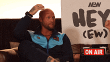 a man holding a sign that says hey ew