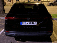 a black vw passat with a license plate that says hhw9014e