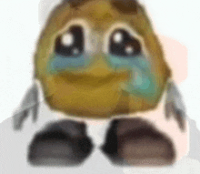 a close up of a cartoon character with a sad face and tears coming out of its eyes .